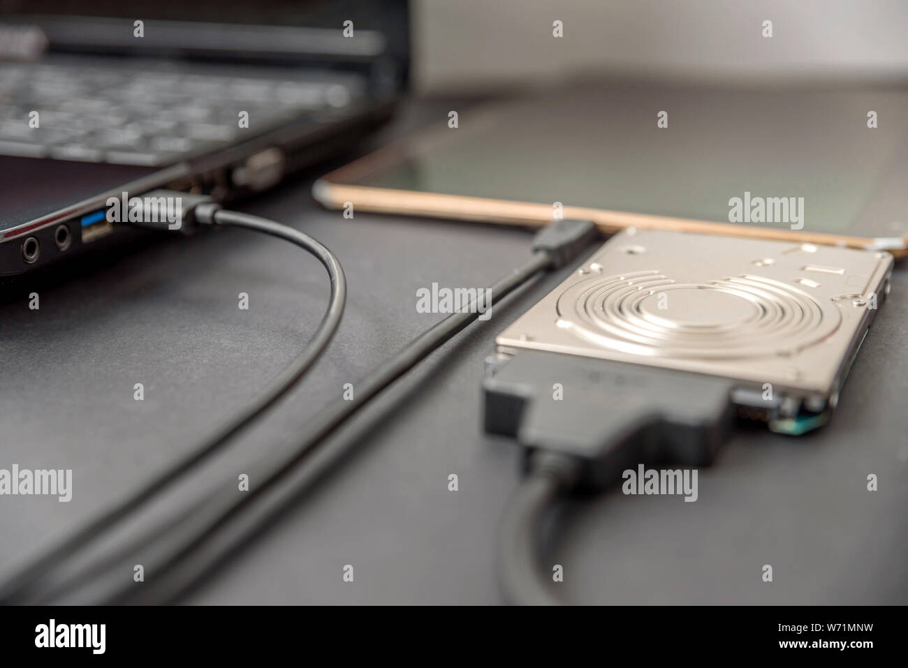 hdd 2.5 internal hard drive disk connected to laptop and digital table via  sata usb cable closeup view Stock Photo - Alamy