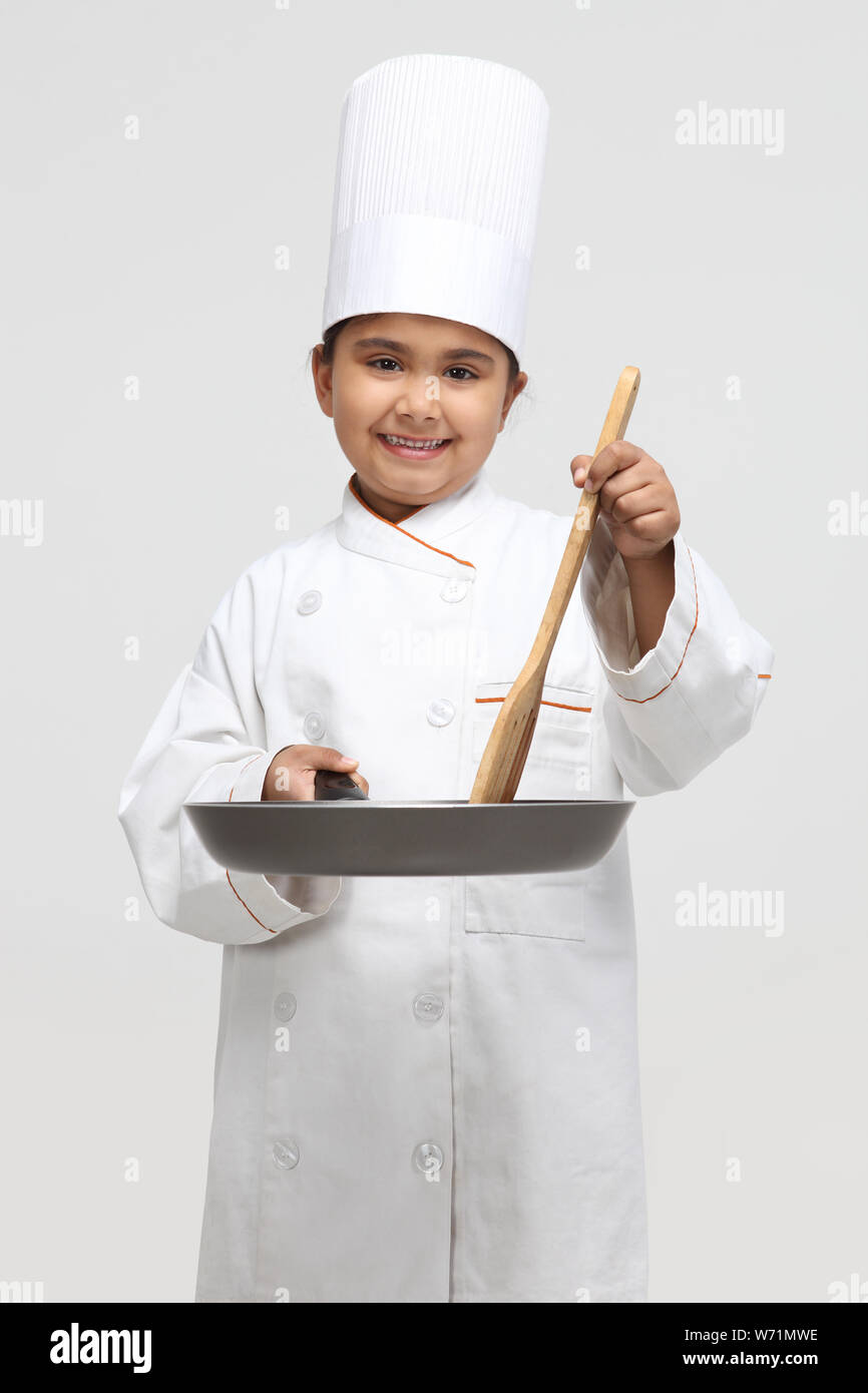 Child chef preparing food Stock Photo
