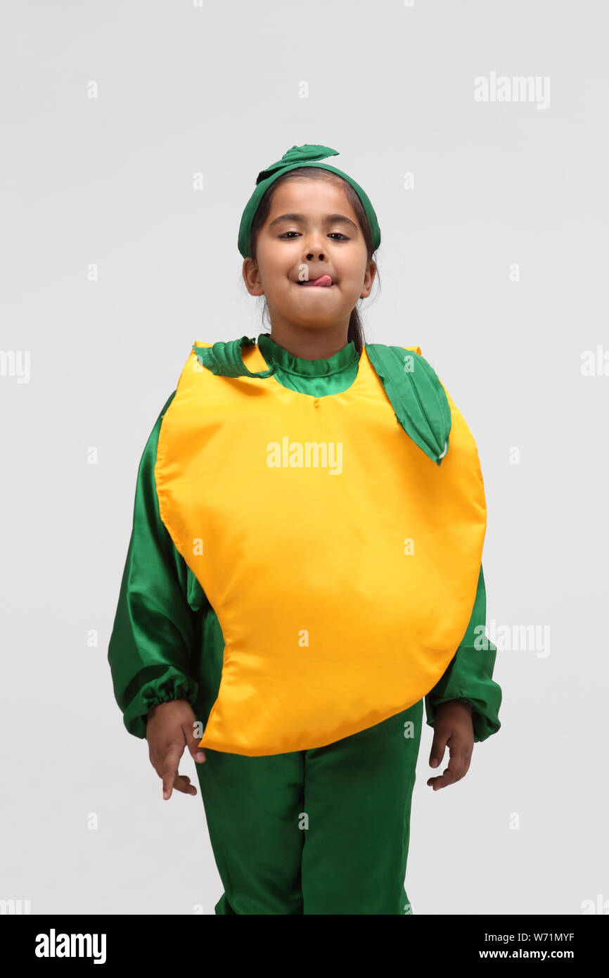 Girl dressed up a mango Stock Photo