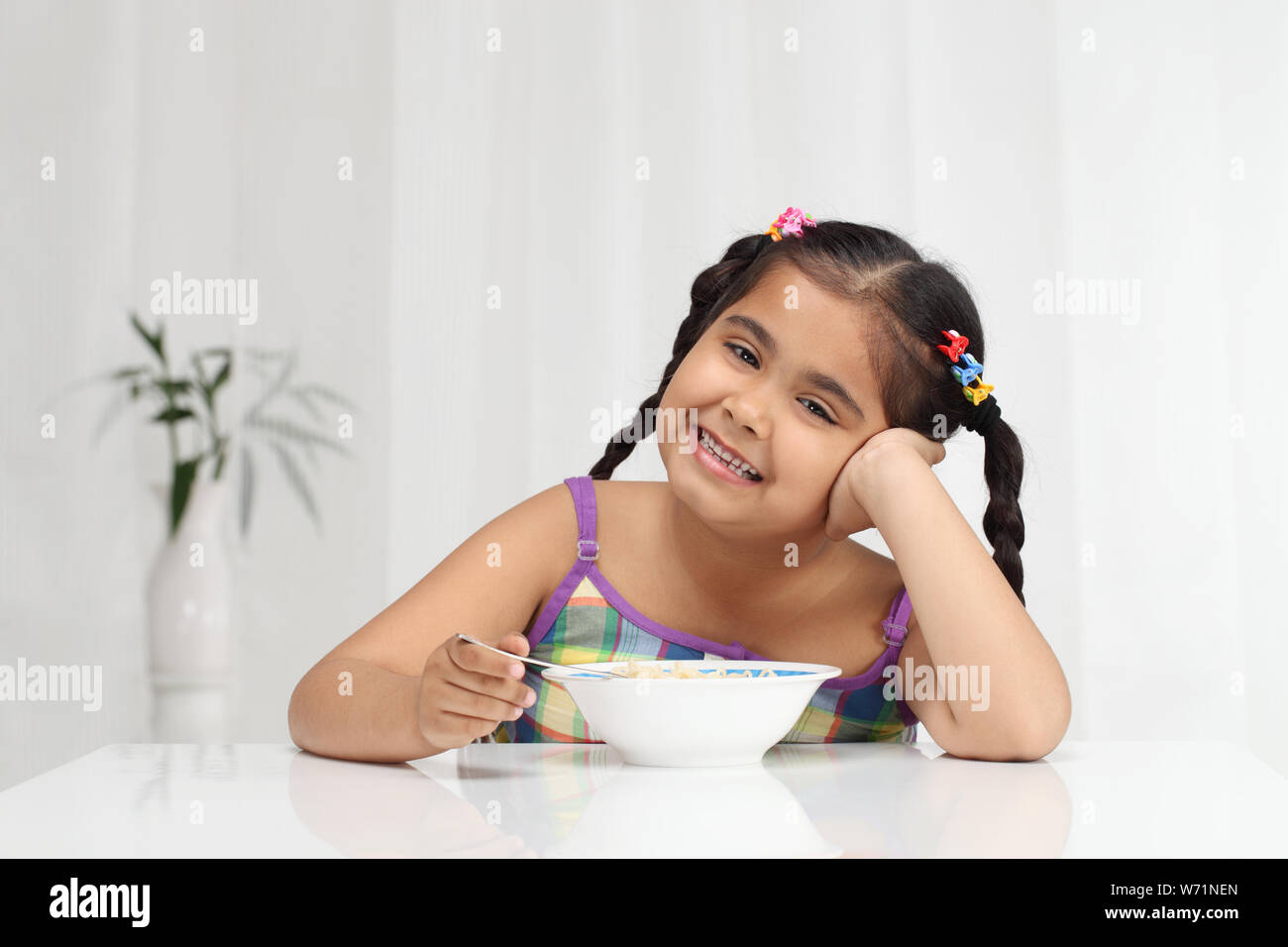 Girl eating noodles Stock Photo