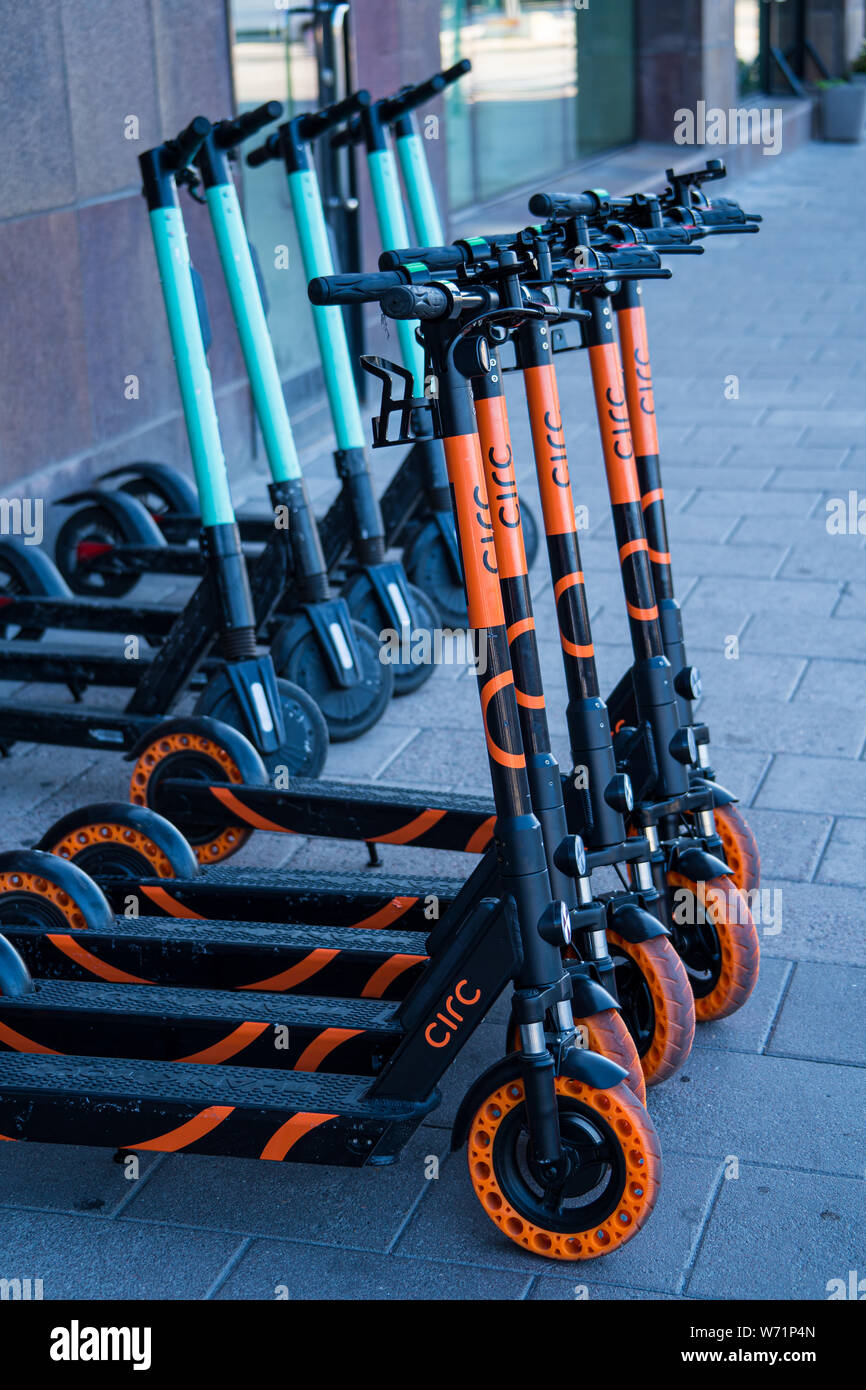 Electric scooters for public use in a street in Stockholm, Sweden. Zero emission sustainable transport Stock Photo