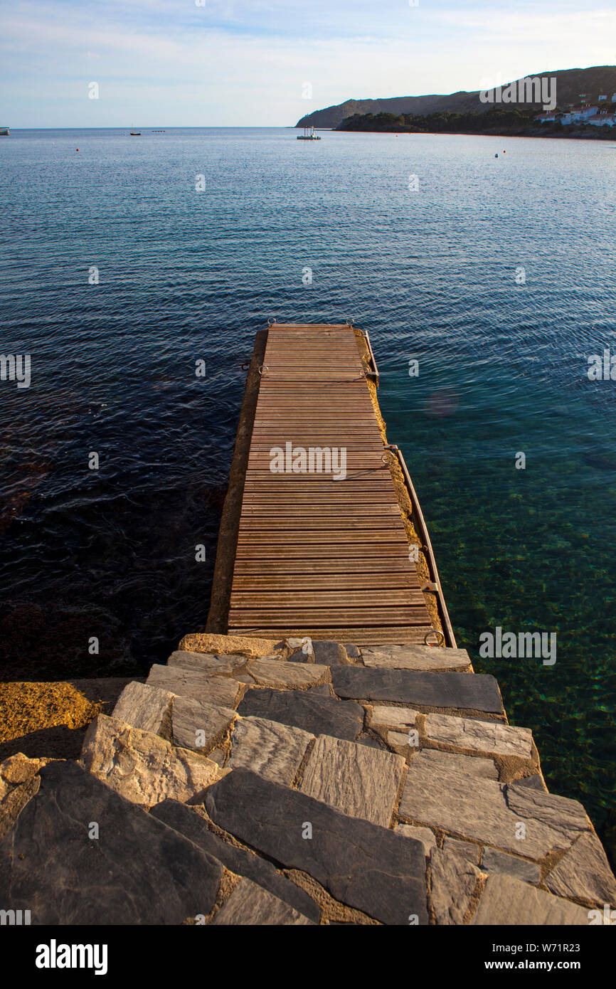 December light falls on the harbour jetty in Cadaqués, Catalonia. Stock Photo