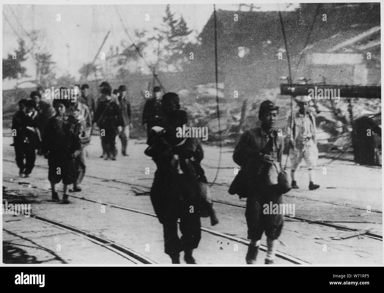 [Survivors moving along the road after the atomic bombing of Nagasaki, Japan.] Stock Photo