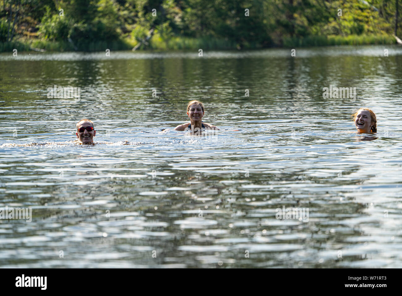 People wild swimming in the Black River (Svartälven), Sweden Stock Photo