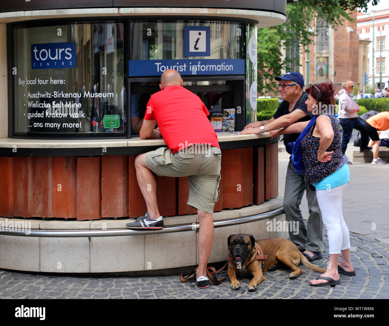 Cracow. Poland. Tourist information kiosk.Tourist with the dog getting info. Stock Photo