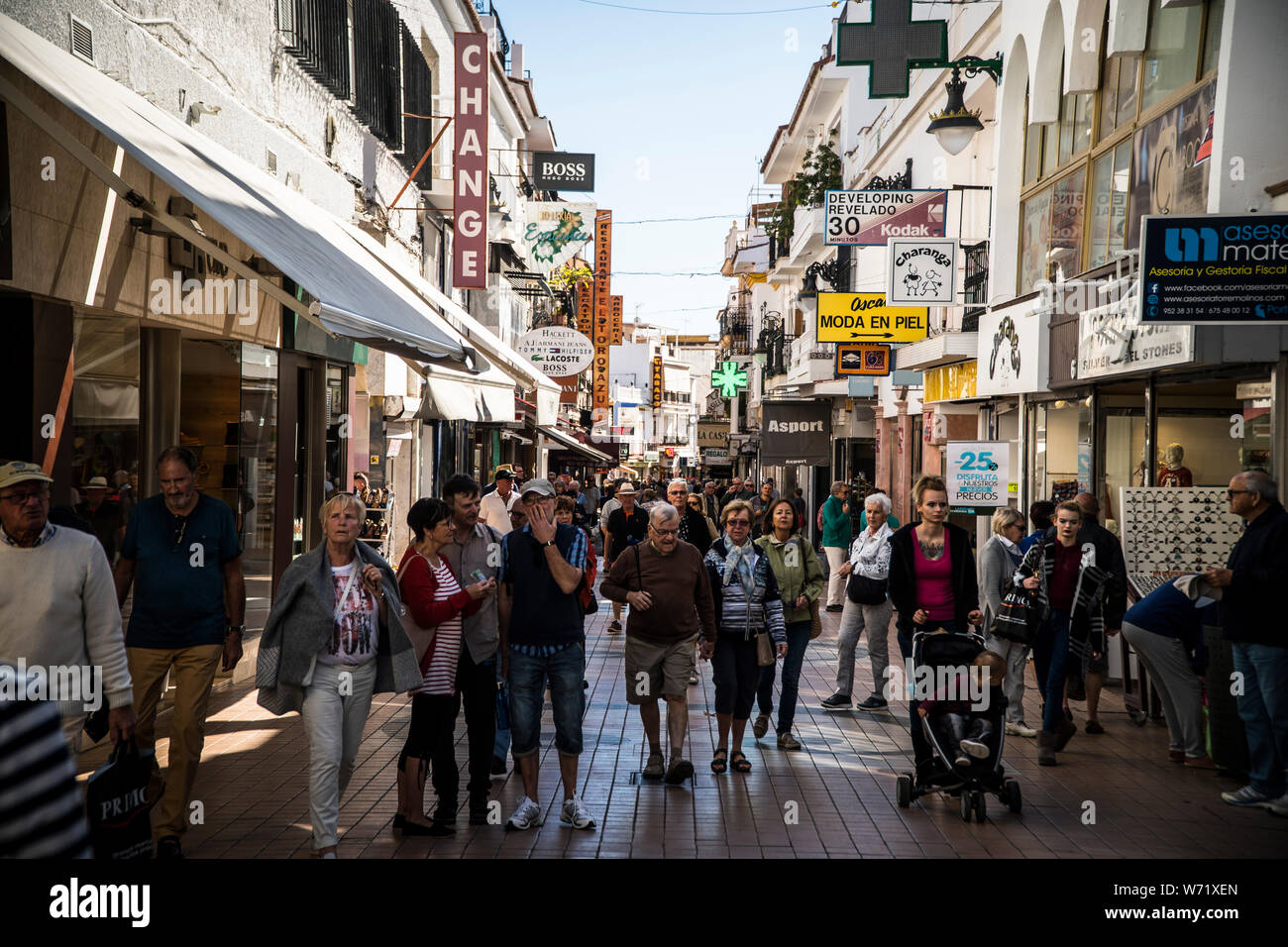 NOVEMBER 10, 2017 - TORREMOLINOS, SPAIN. Crowds of tourists on a busy shopping street ,Calle san Miguel in the centre of Torremolinos Stock Photo