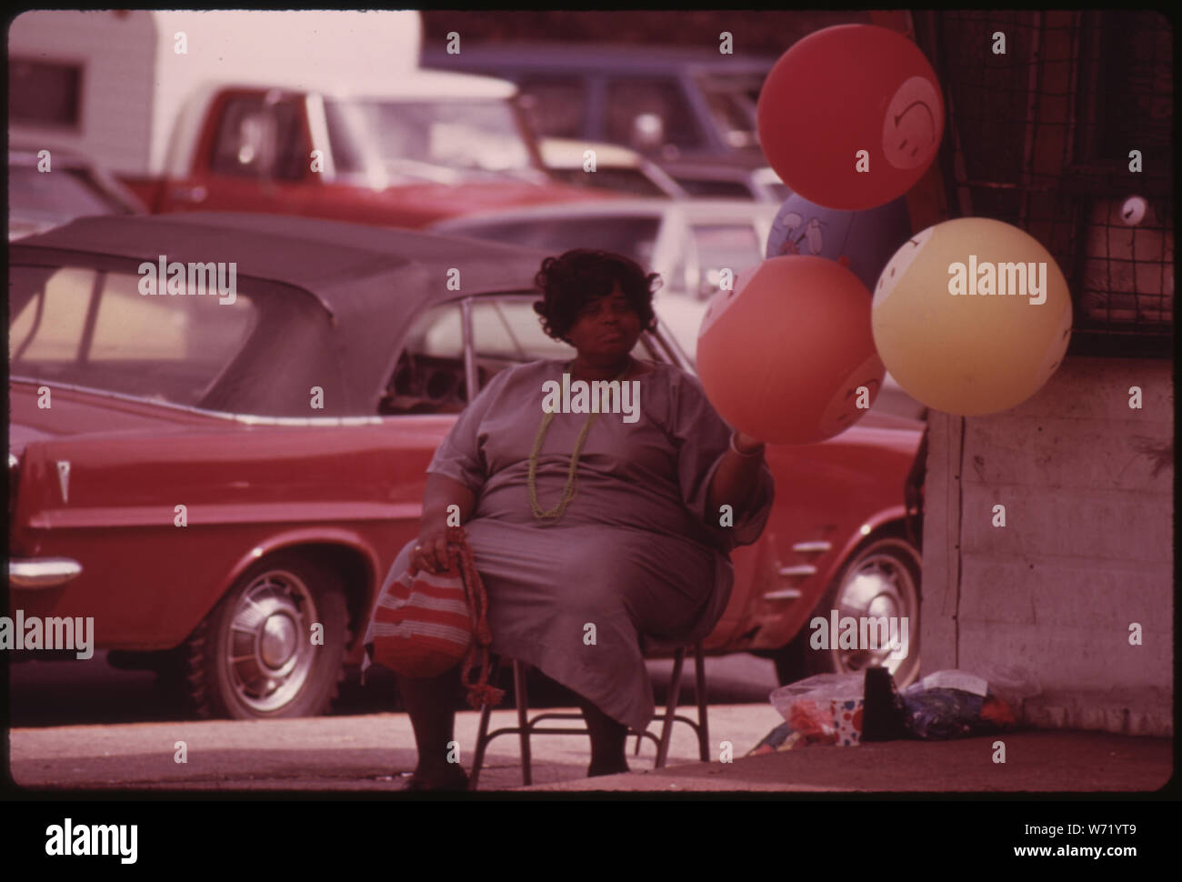 BLACK WOMAN SELLING GAS FILLED HAVE A HAPPY DAY BALLOONS ON A CHICAGO SOUTH SIDE STREET CORNER AT SOX PARK BASEBALL FIELD MANY OF THE CITY'S BLACK BUSINESS OWNERS STARTED WITH SMALL OPERATIONS SUCH AS THIS AND GREW BY WORKING HARD. TODAY CHICAGO IS BELIEVED TO BE THE BLACK BUSINESS CAPITAL OF THE UNITED STATES. BLACK ENTERPRISES MAGAZINE REPORTED IN 1973 THAT THE CITY HAD 14 OF THE TOP 100 BLACK OWNED BUSINESSES IN THE COUNTRY, ONE MORE THAN NEW YORK CITY Stock Photo