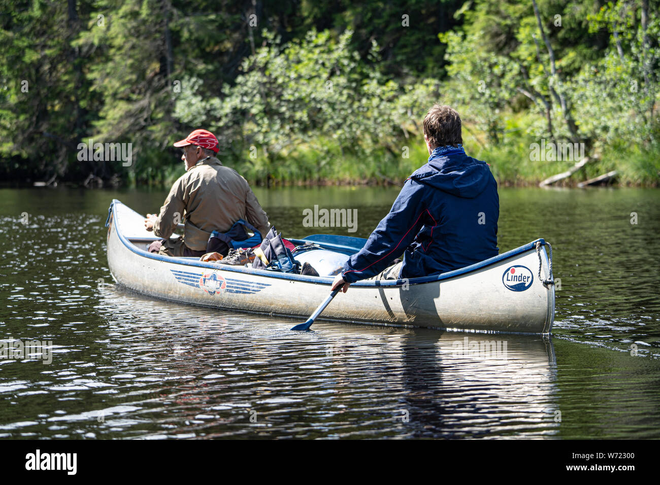 Two people canoeing on the Black River (Svartälven) in the wilderness