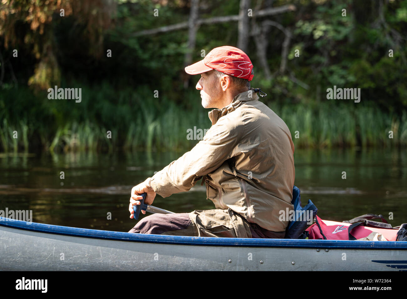 A man canoeing on the Black River (Svartälven) in the wilderness, Sweden Stock Photo