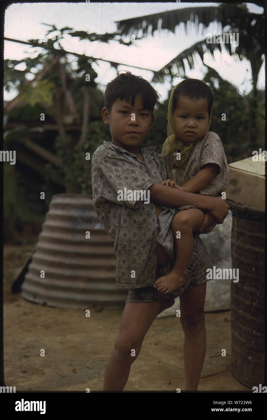 Camp Campbell, Phu Bai, Republic of Vietnam... A Vietnamese boy carries a young child. Stock Photo