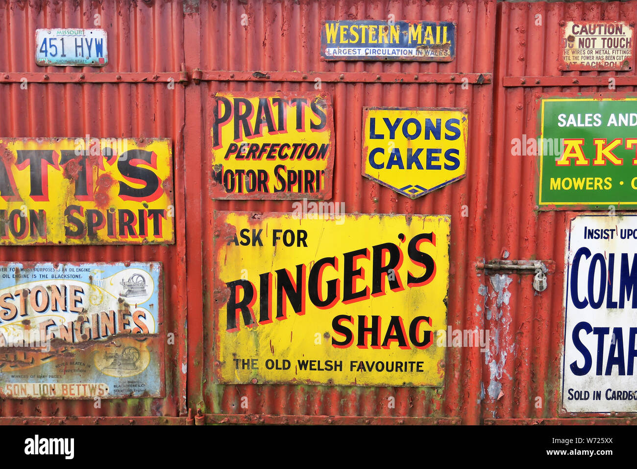 Enameled metal advertising boards or signs from a bygone era with design of  embossed words and illustration. Peeling and rusted enamel paint of vintag  Stock Photo - Alamy