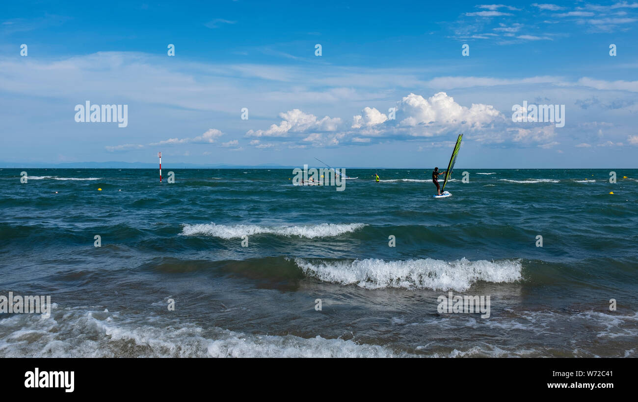 LIGNANO SABBIADORO, ITALY - 15 JULY 2019: windsurfer on a windy day Stock Photo