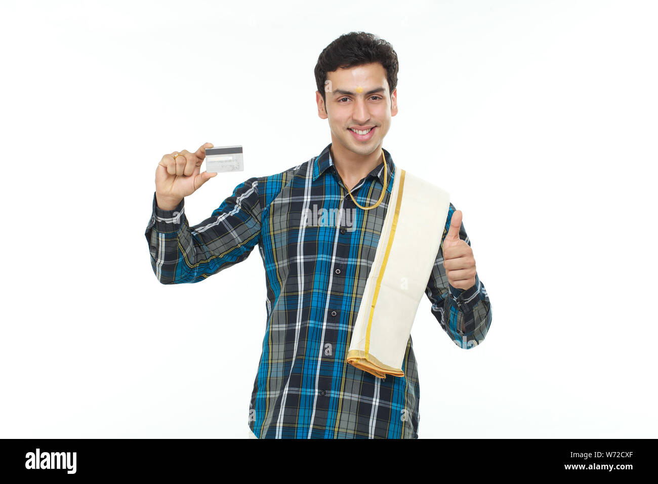 South Indian man showing thumbs up sign and holding credit card Stock ...