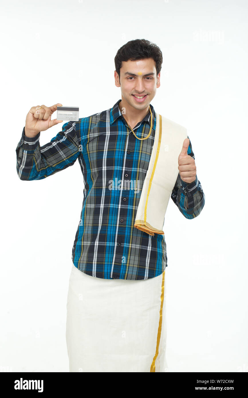 South Indian man showing thumbs up sign and holding credit card Stock ...