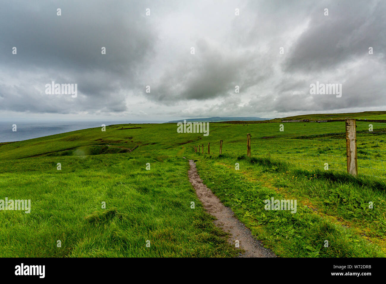 Irish landscape of the spectacular coastal route walk from Doolin to the Cliffs of Moher, geosites and geopark, Wild Atlantic Way, cloudy spring day Stock Photo