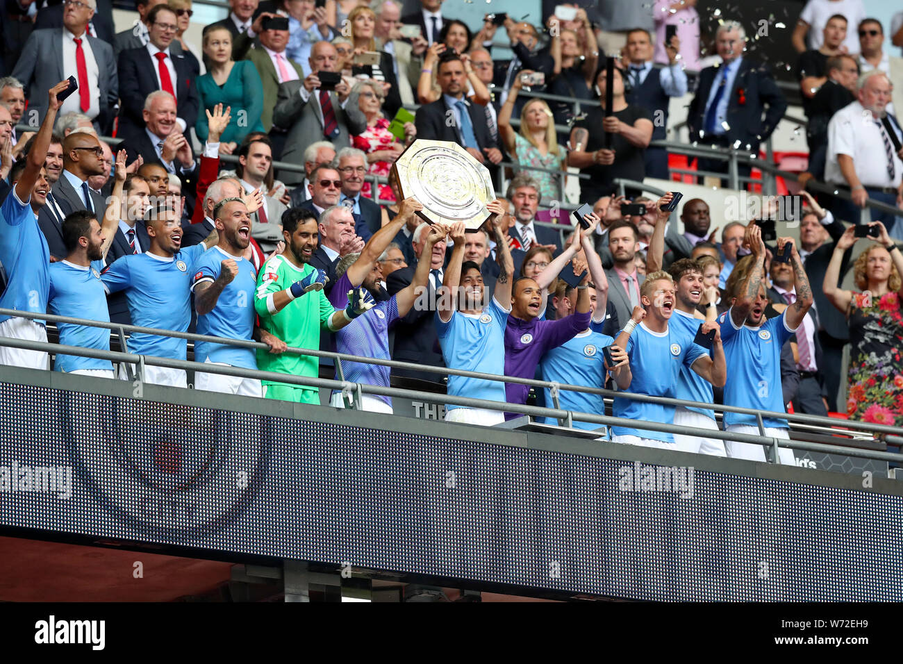Manchester City's Sergio Aguero and David Silva lift the trophy after their side win the Community Shield match at Wembley Stadium, London. Stock Photo