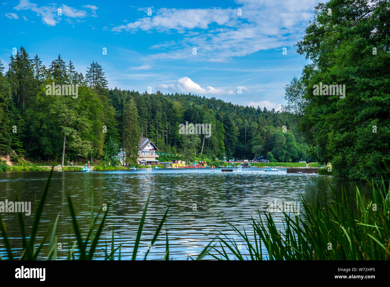 Kaisersbach, Germany, July 20, 2019, People enjoying summer vacation in nature reserve of lake ebnisee swimming, bathing, standup paddeling and in ped Stock Photo