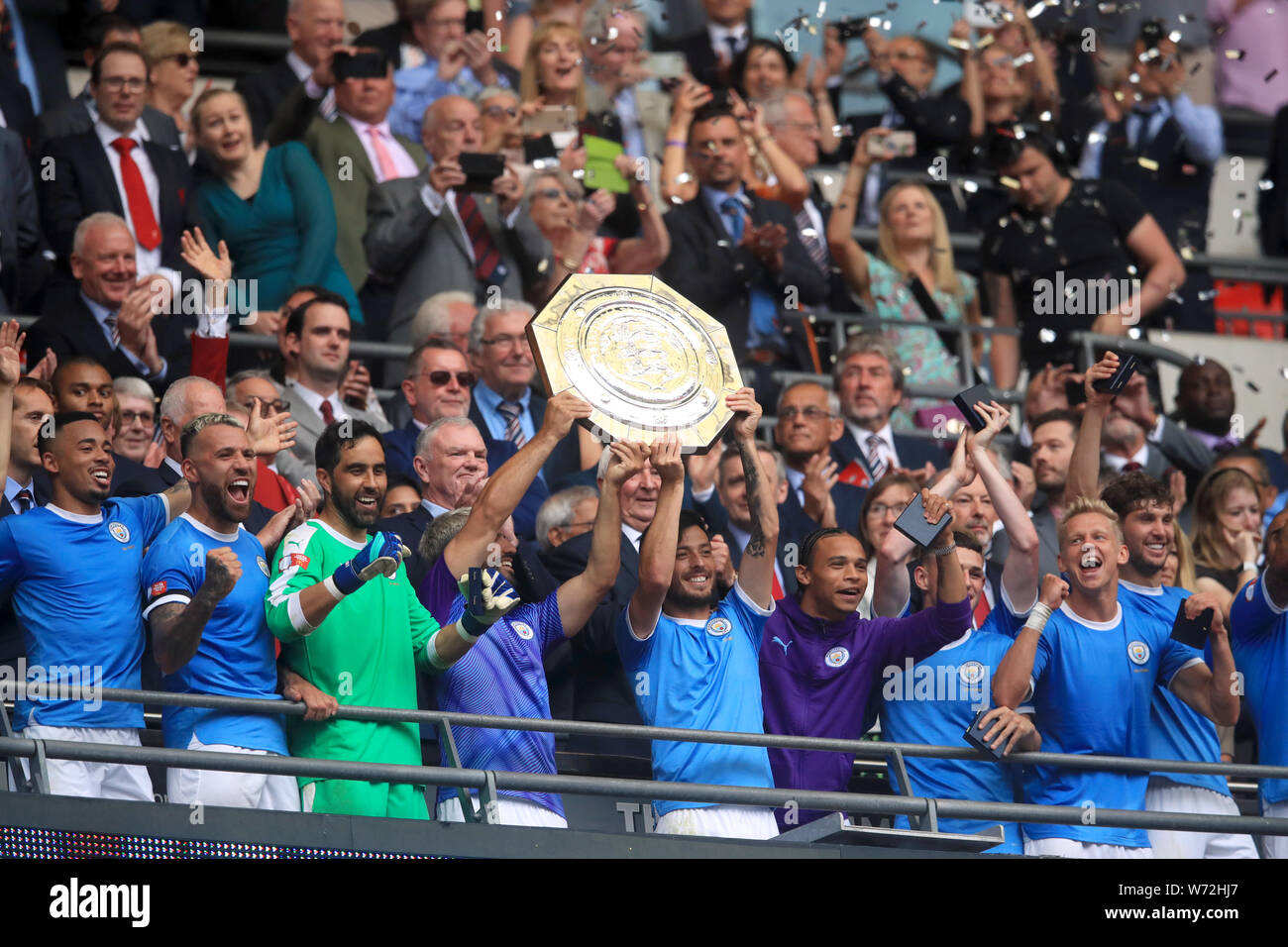Manchester City's Sergio Aguero (left) and David Silva lift the trophy after their side win the Community Shield match at Wembley Stadium, London. Stock Photo