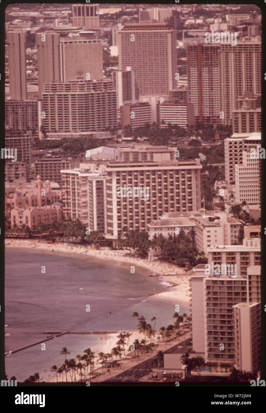 MASSED HIGHRISES OF WAIKIKI DISTRICT, FAVORITE OF TOURISTS SEEN FROM TOP OF DIAMOND HEAD, THE FAMOUS EXTINCT VOLCANO. THE WAIKIKI IMPROVEMENT ASSOCIATION HAS FORMED AN ARCHITECTURAL DESIGN REVIEW BOARD TO OVERSEE SUCH BUILDING, BUT IT IS PROBABLY TOO LATE. IN 1963 THERE WERE 9,203 HOTEL ROOMS IN ALL OF OAHU ISLAND. TODAY THERE ARE SOME 26,000 ROOMS, MOST OF THEM HERE IN WAIKIKI Stock Photo