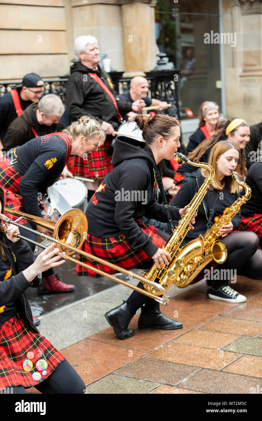 music band with traditional Scottish kilts performing in Glasgow city center Stock Photo