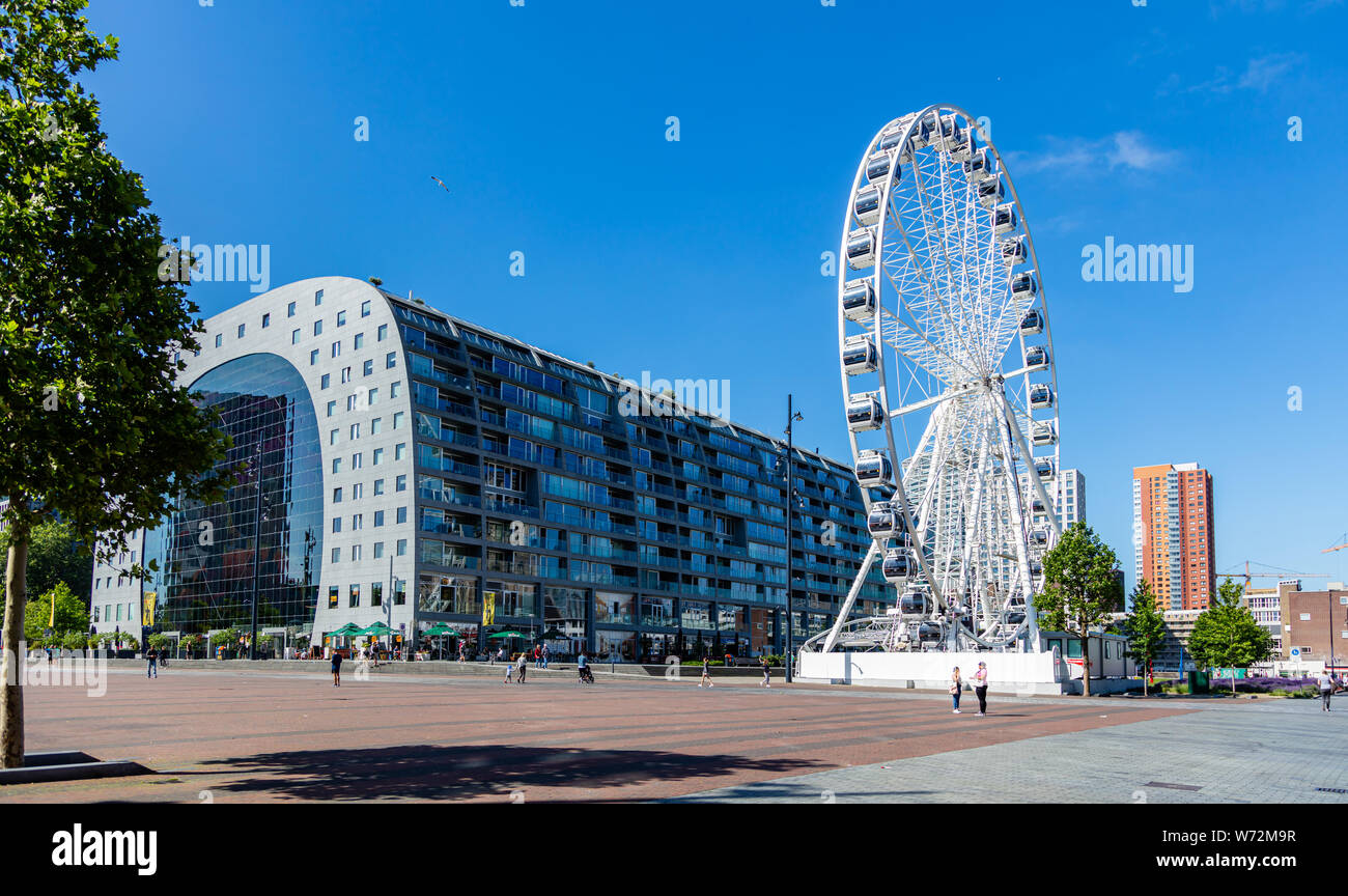 Rotterdam, Netherlands. June 27, 2019.  Market Markthal exterior view, ferris wheel and people, spring sunny day Stock Photo