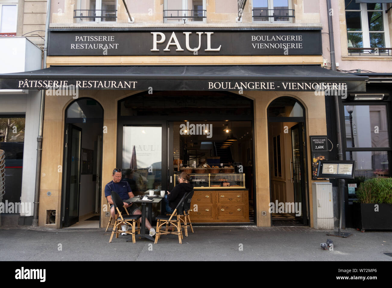Couple sitting at the Paul coffe shop and bakery, Luxembourgcity