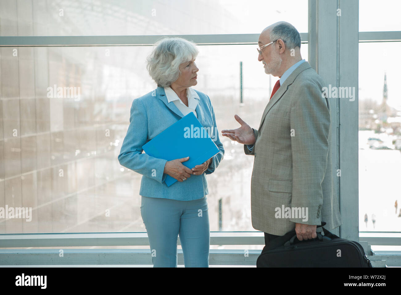 Senior business colleagues man and woman having conversation at work Stock Photo