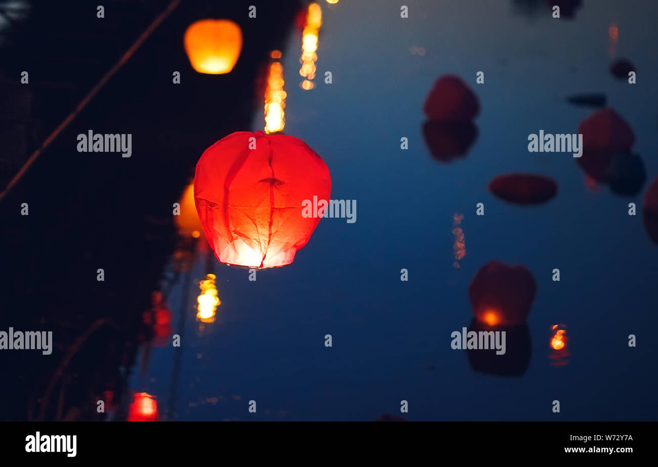 Sky Lantern Festival. Flying lantern in the dark sky at night Stock