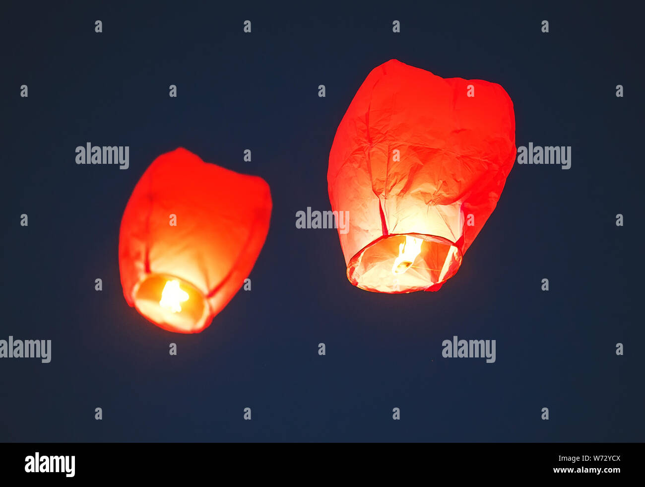 Flying lantern in the dark sky at night Stock Photo