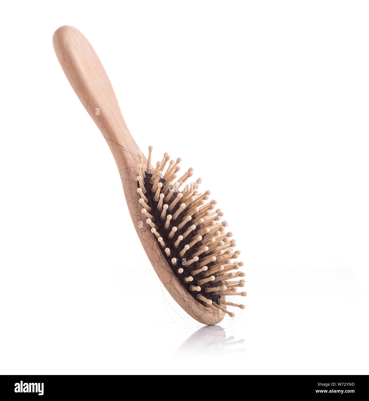 Wooden comb with black hair loss problem studio shot and isolated on white background Stock Photo