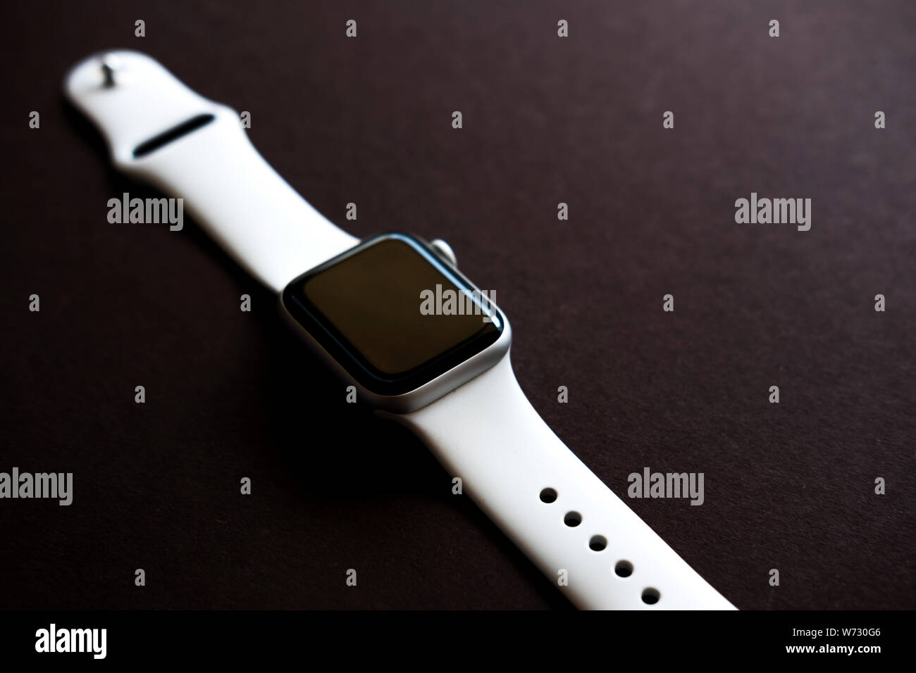 Chekhov, Russia - July 19, 2019: Apple Watch Series 4 white color. A new watch from an Apple company closeup isolated on dark background Stock Photo