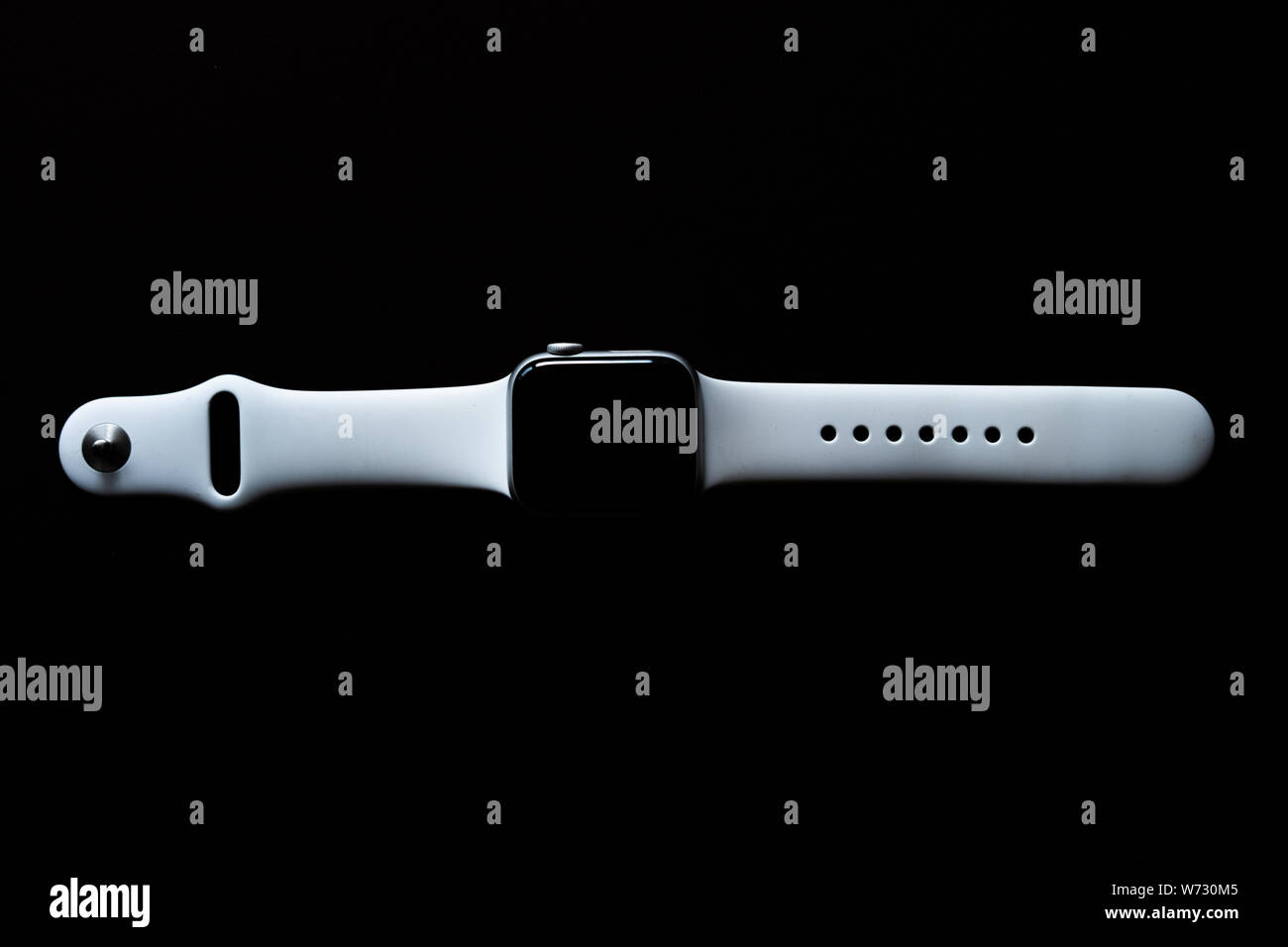 Chekhov, Russia - July 19, 2019: Apple Watch Series 4 white color. A new watch from an Apple company closeup isolated on dark background Stock Photo