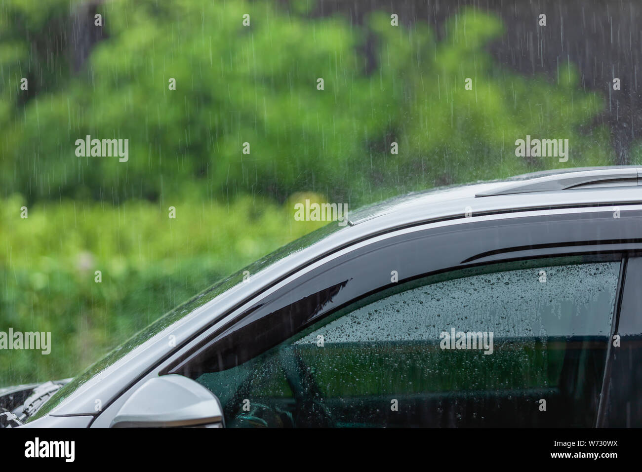Roof of modern car parking at outdoor while raining, How to take care the car in rainy season concept Stock Photo