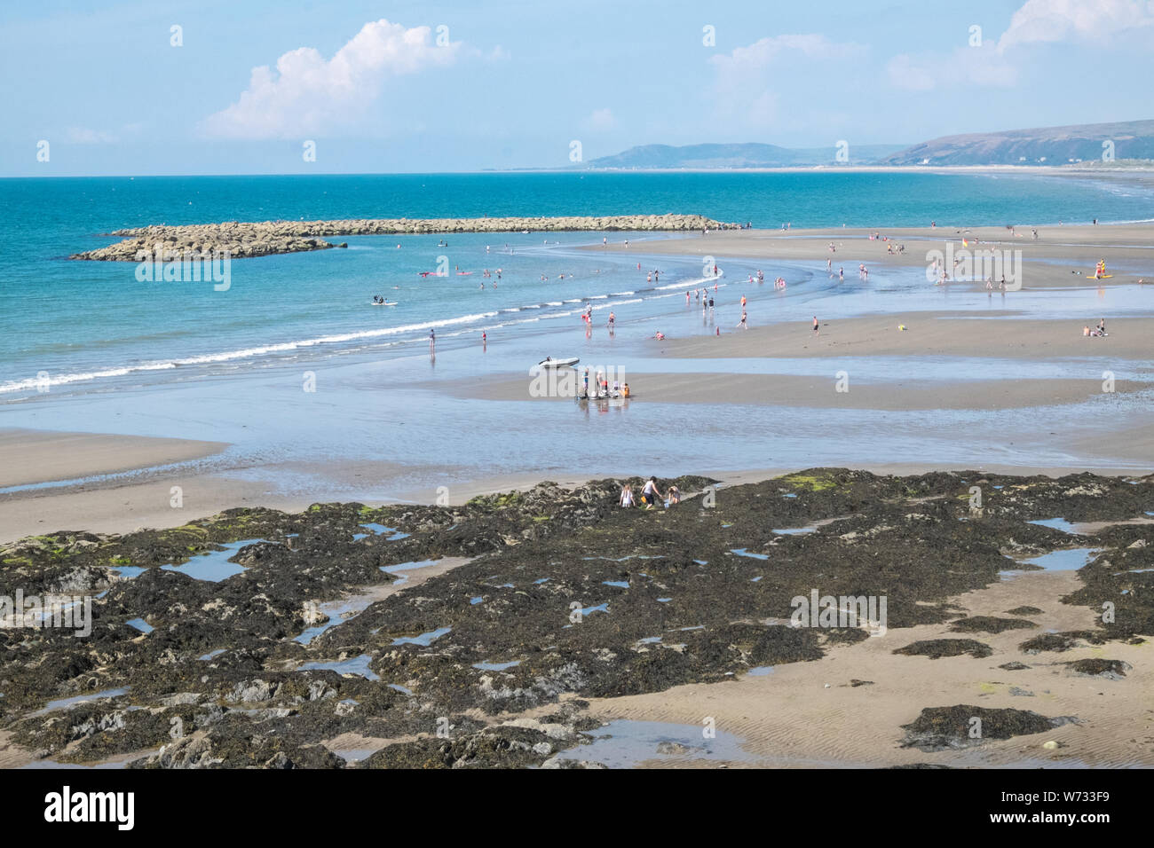Holiday,makers,Low tide,Borth Beach,at,seaside,resort,village,town,at