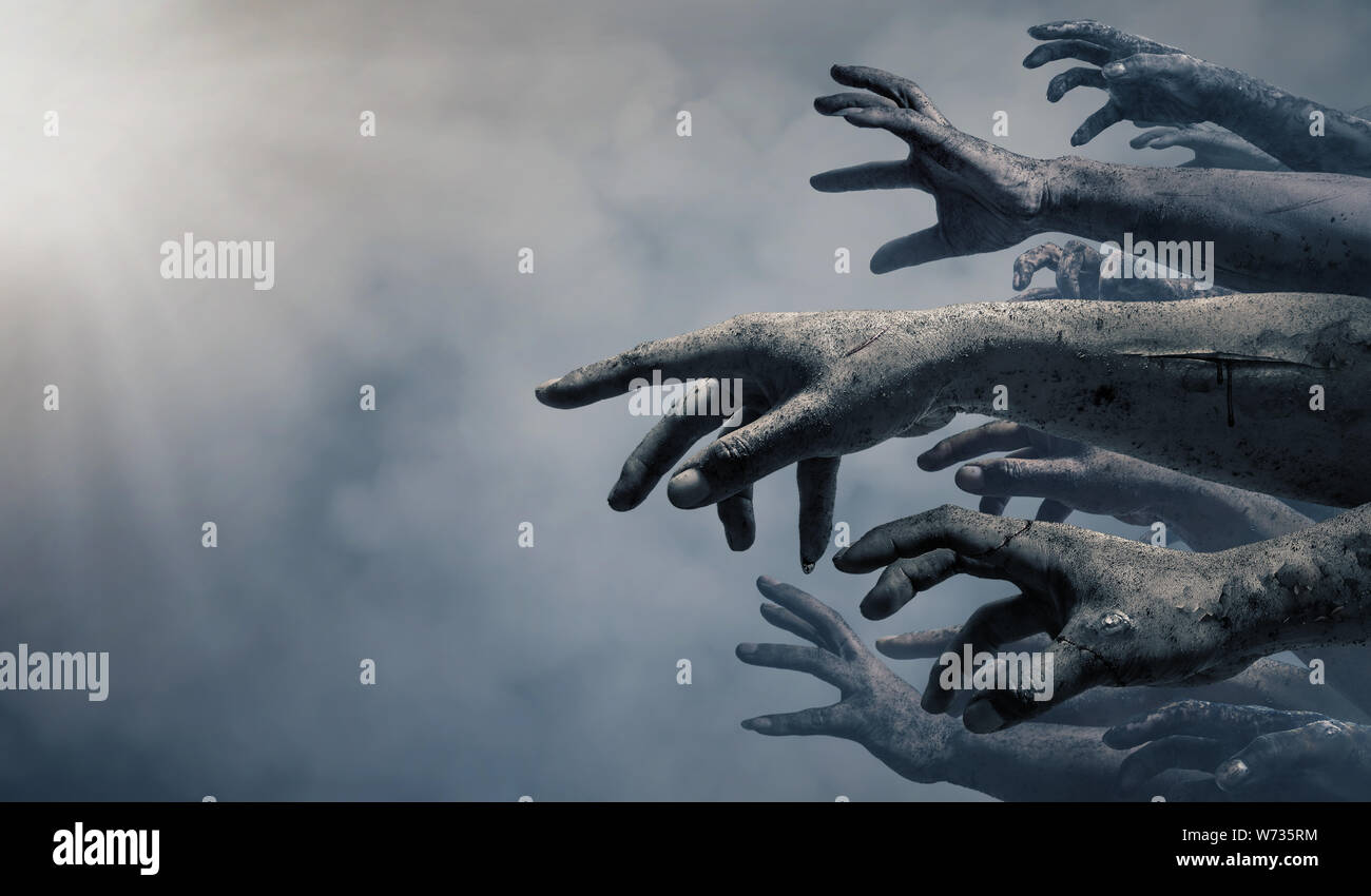 Zombie hands rising in dark Halloween night. Stock Photo