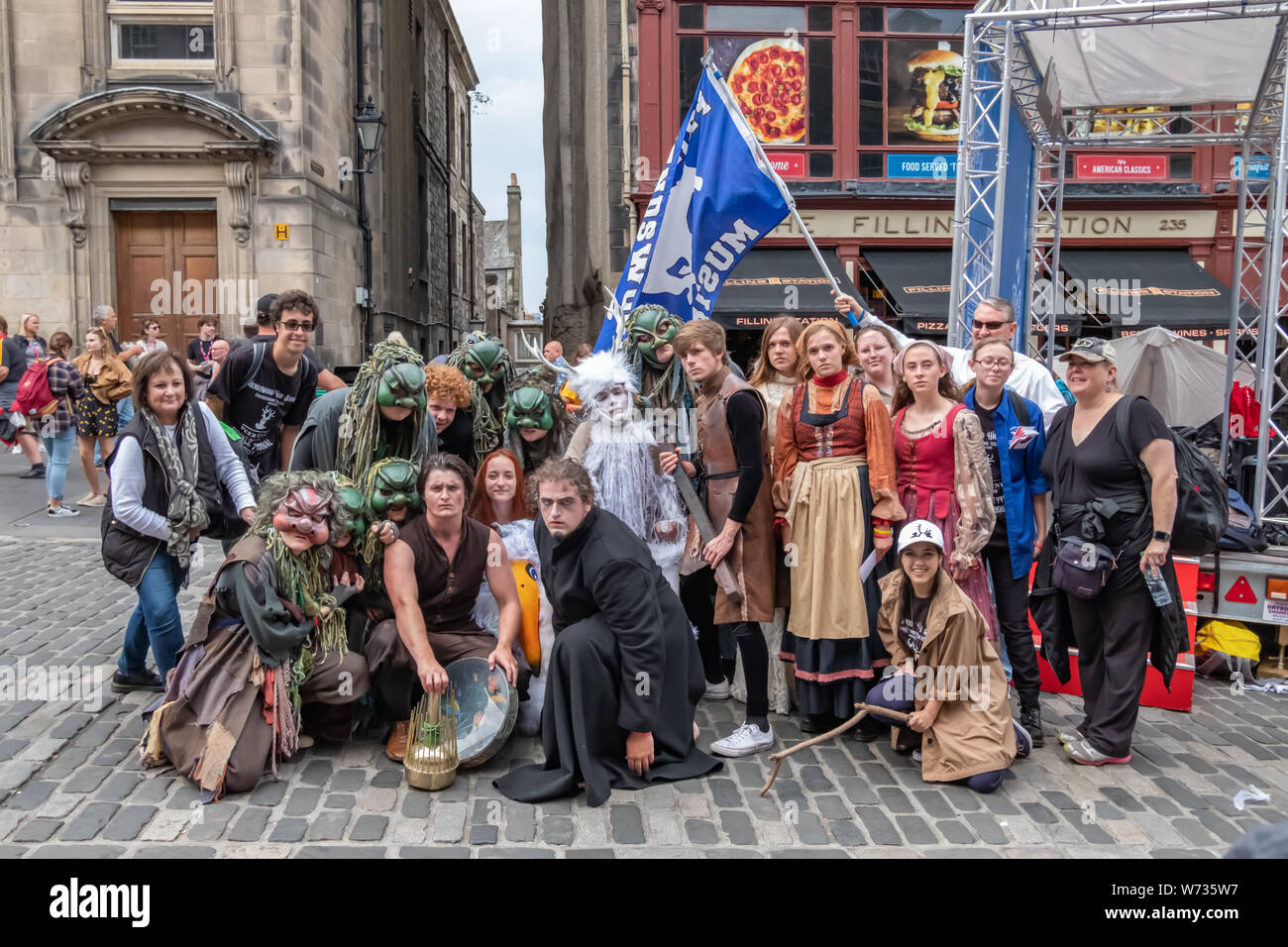 Edinburgh, Scotland, UK. 4th August, 2019. Performers on the Royal Mile promoting the Friendswood High School, Texas presentation of Peer Gynt by Henrik Ibsen on at Central Hall venue 295 during the Edinburgh Fringe Festival. Credit: Skully/Alamy Live News Stock Photo
