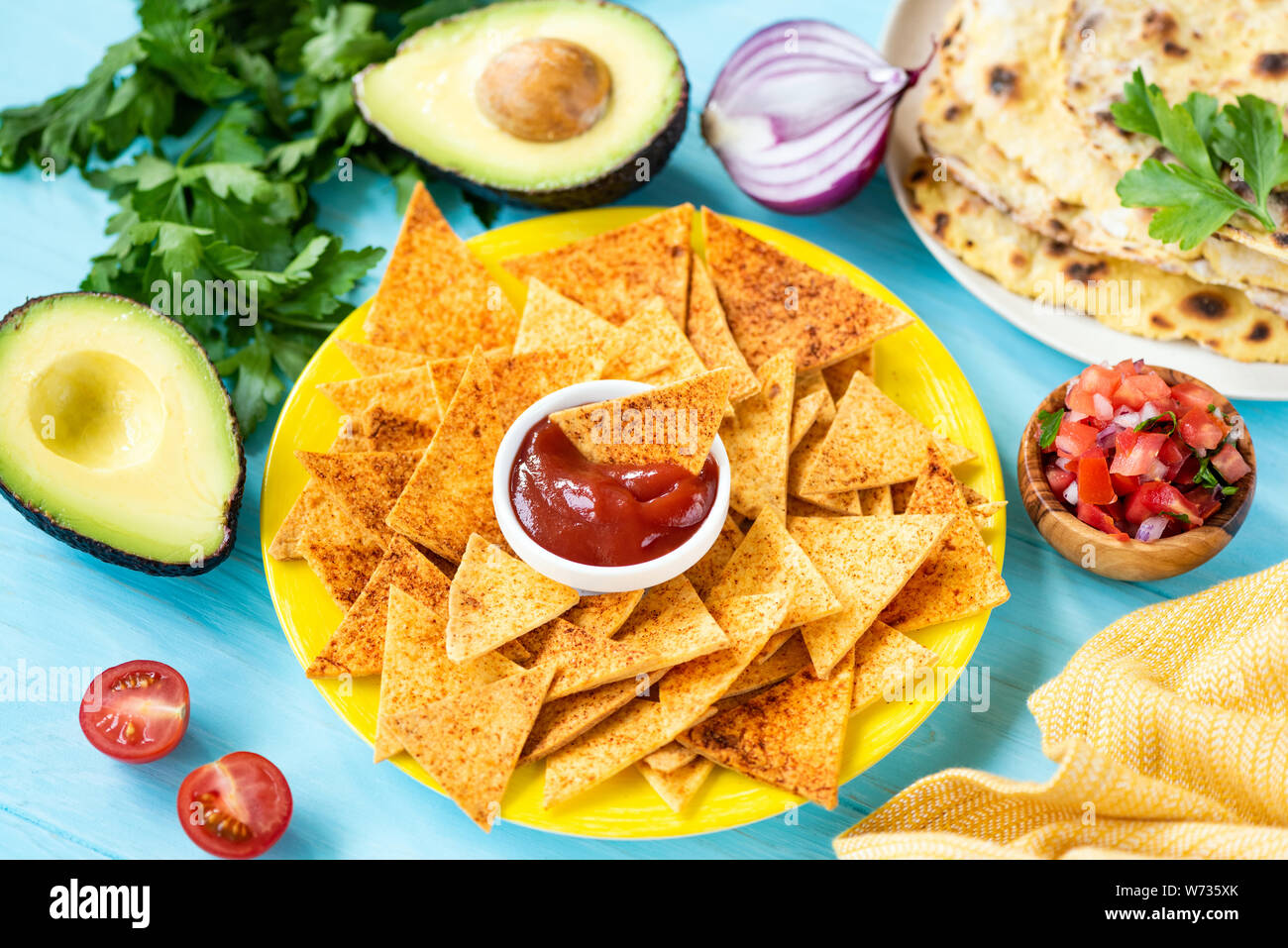 Mexican tortilla chips with paprika and tomato sauce. Tex mex food Stock Photo