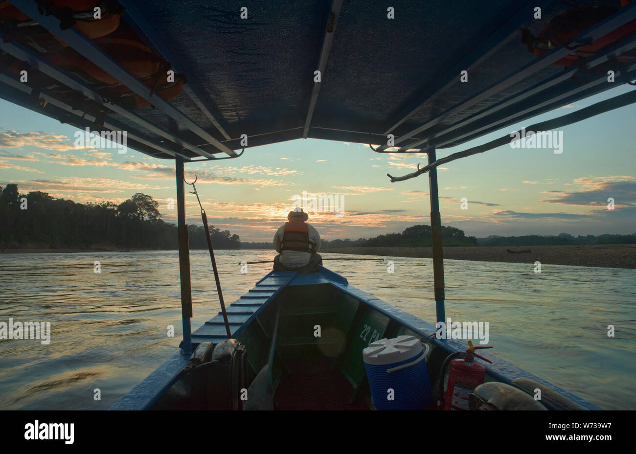 Navigating the Tambopata River at sunrise, Tambopata National Reserve, Peruvian Amazon Stock Photo