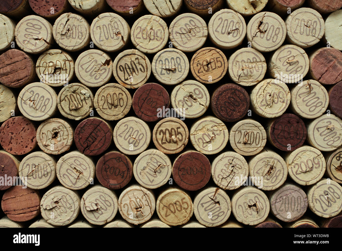 Cork wine bottle tops with numbers of years arranged close to each other. Closeup Stock Photo