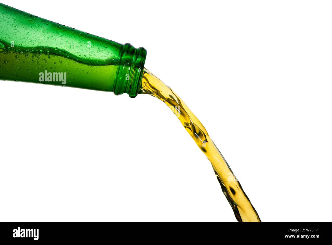Ice cold beer pouring from neck of green bottle. Stop action closeup on