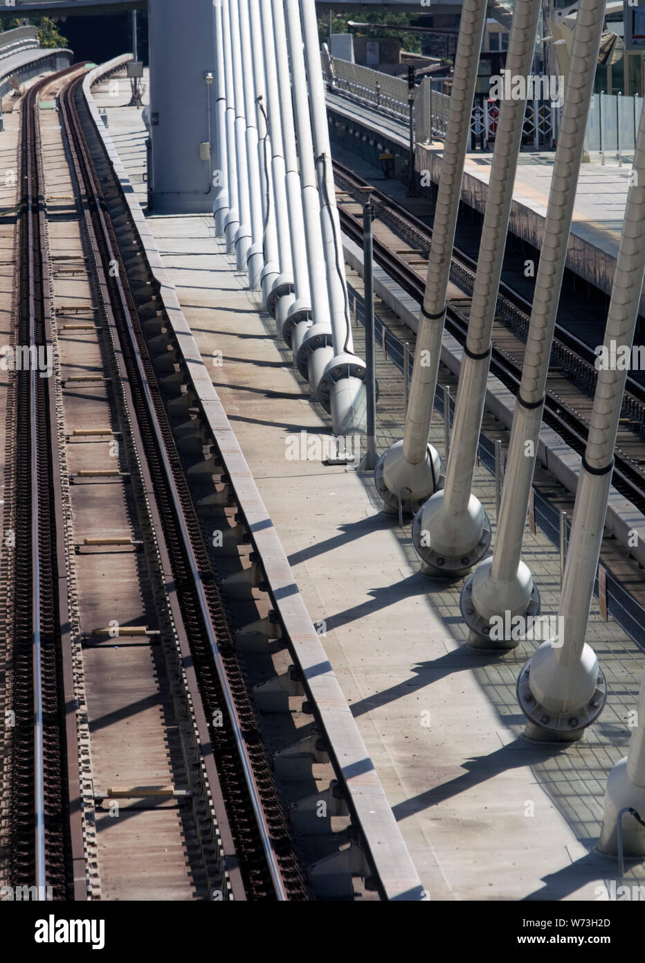 Modern rail suspension bridge detail where suspender cables converge in the middle section on the deck. Stock Photo