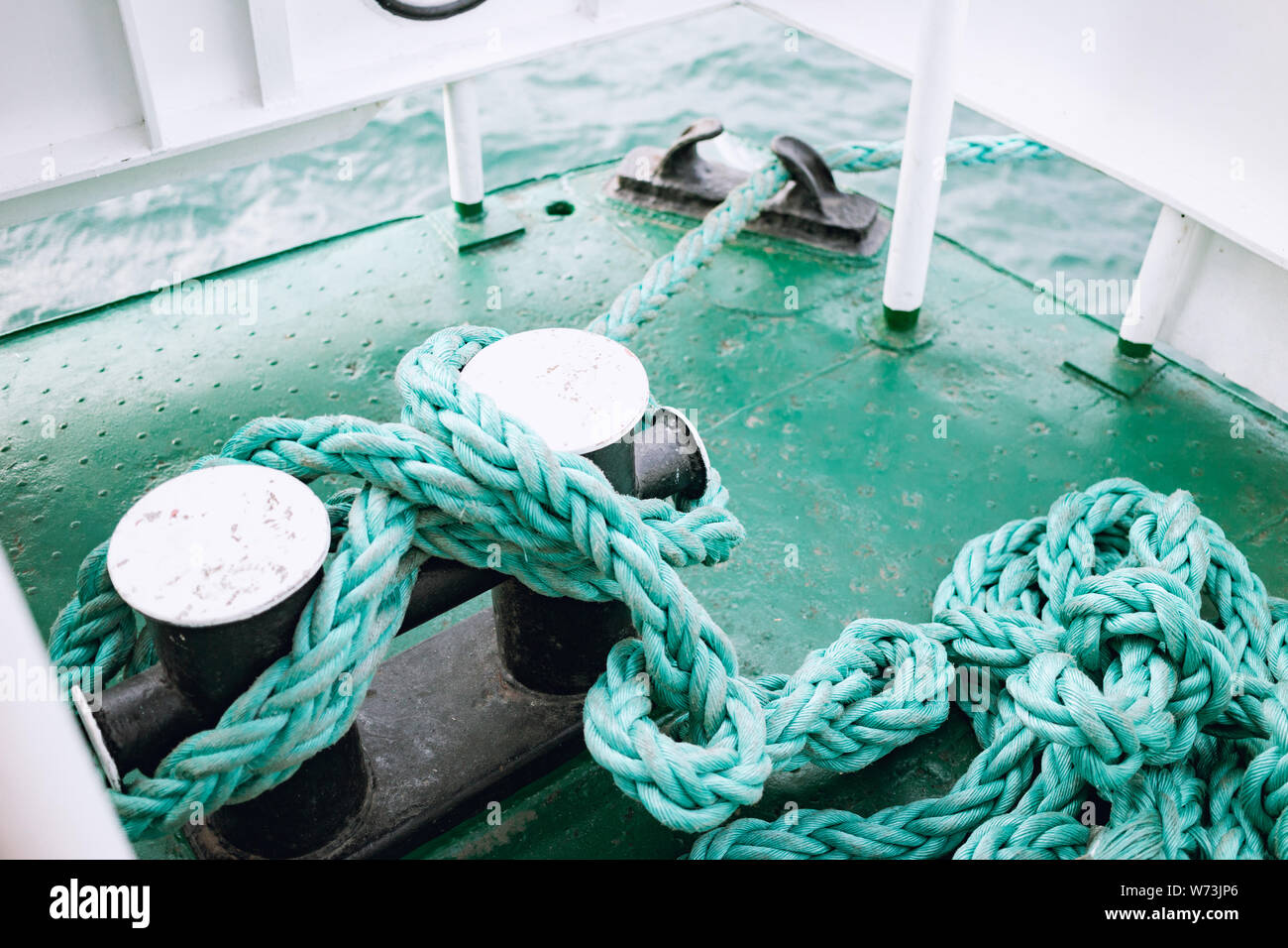 An old blue frayed boat rope. Nautical background. Turquoise nautical rope. Stock Photo