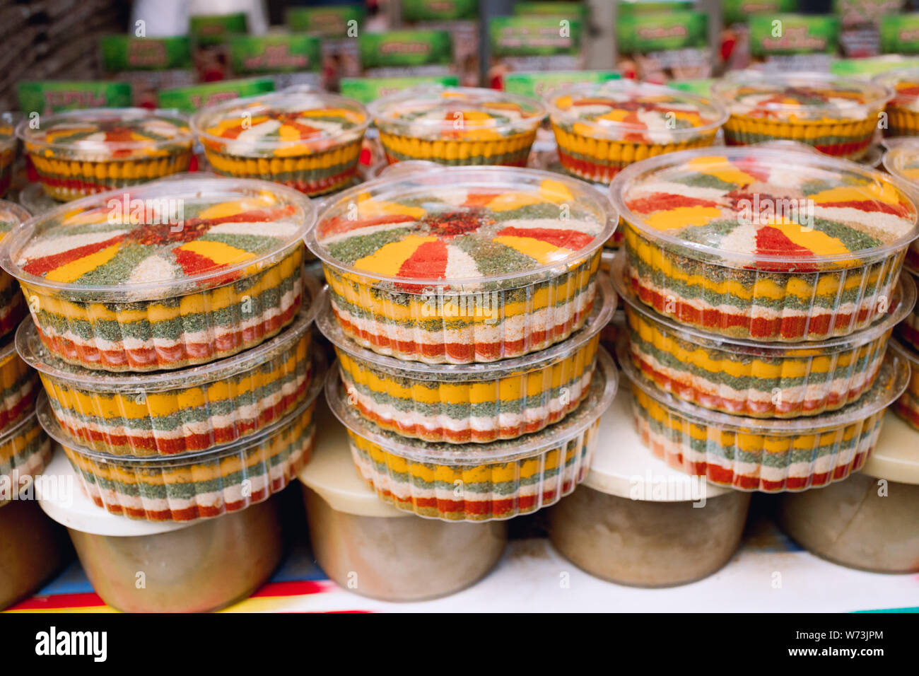 Mixtures of spices. Colorful spices and dried vegetables in jars. Close up counter with various spices in market Stock Photo