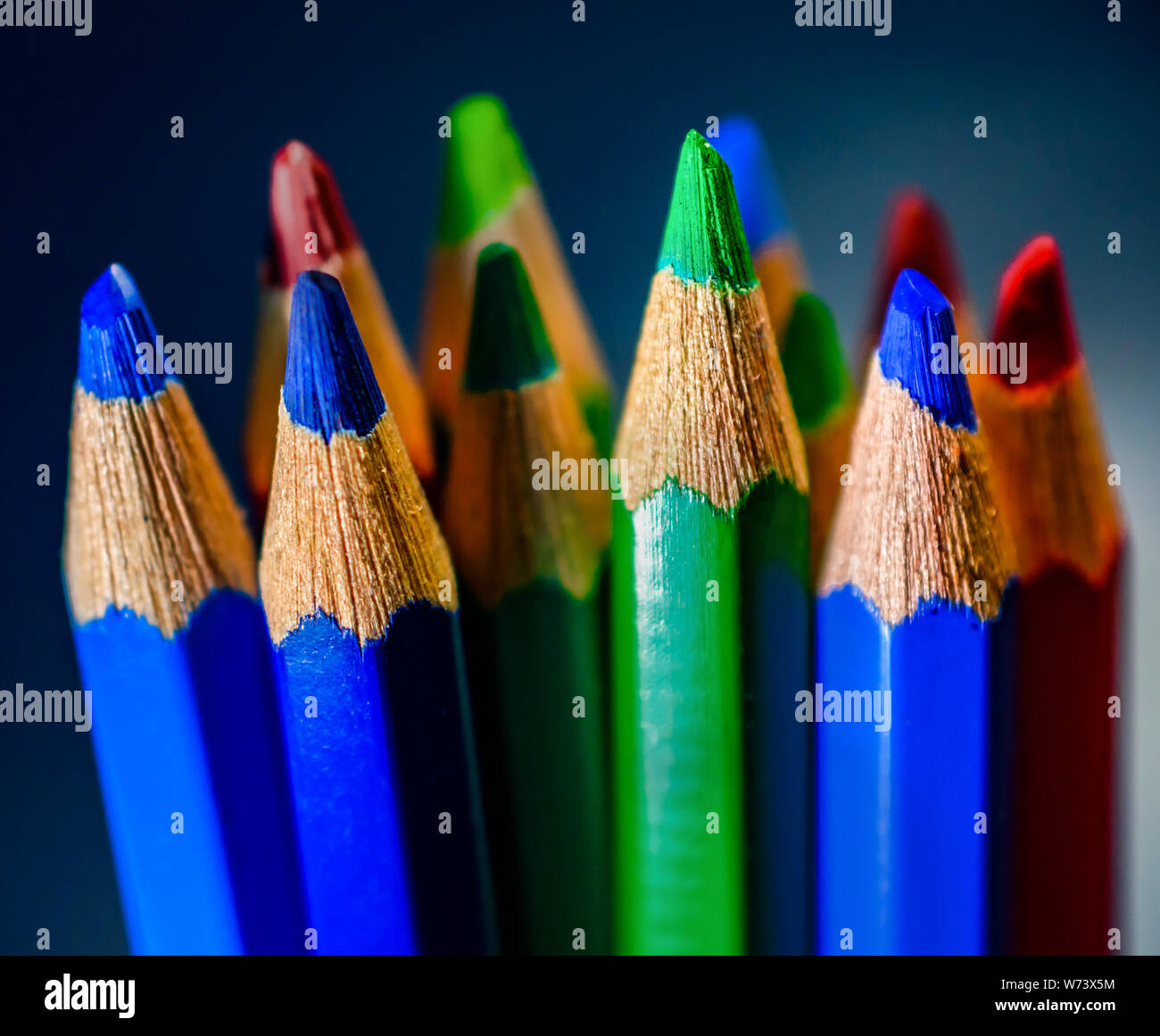Closeup of brightly colored pencils tips with grainy wooden texture Stock Photo