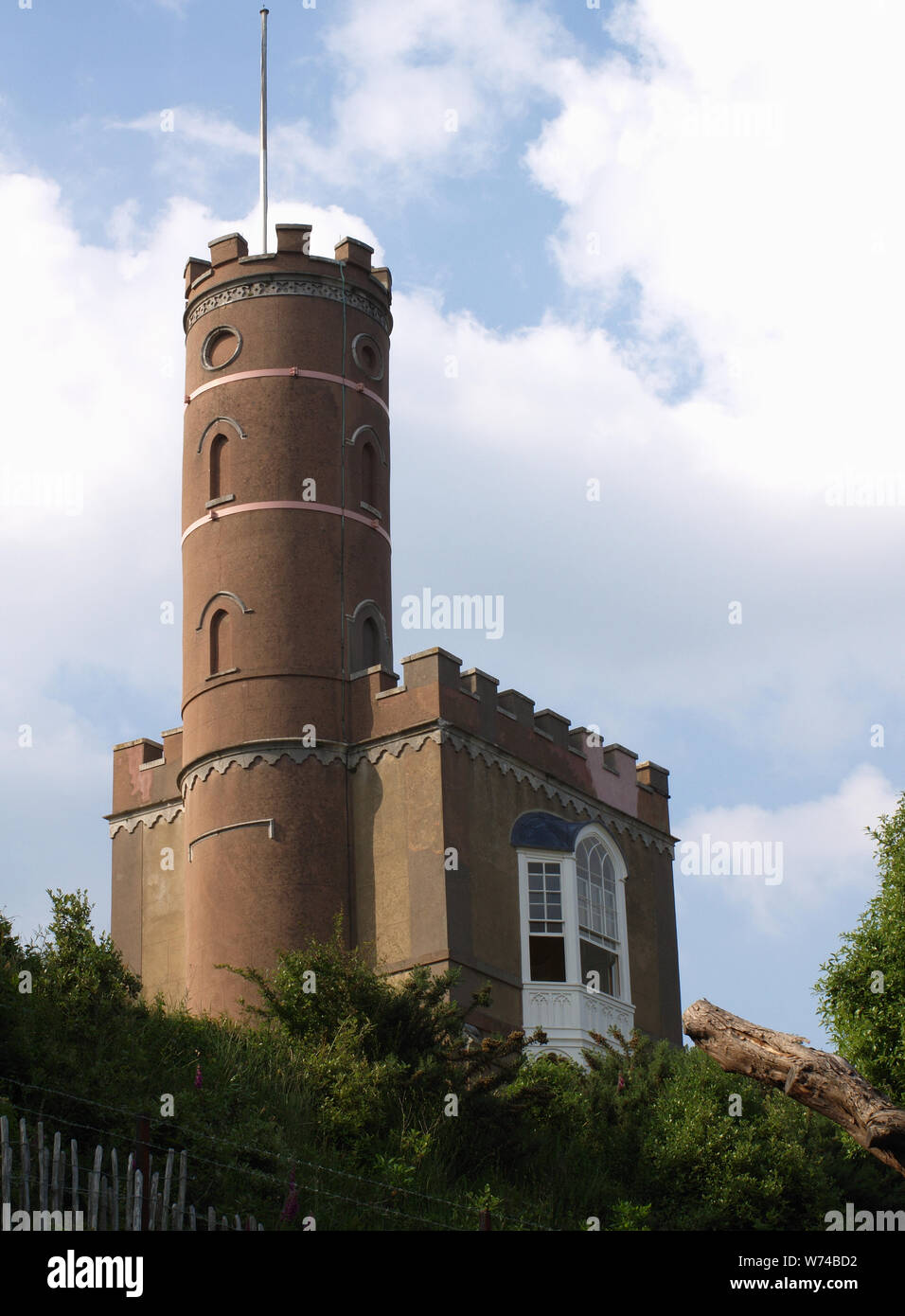 Luttrell's Tower, a 3 story stuccoed yellow brick folly at Calshot
