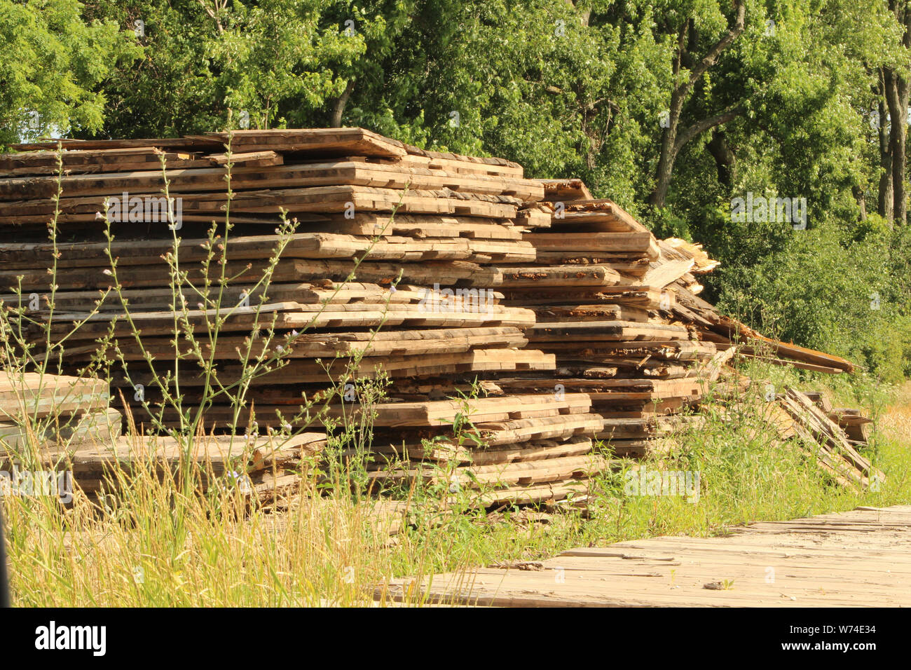 A pile of pallets used by WE Energies to create roads through cornfields during a electric line upgrade. Stock Photo