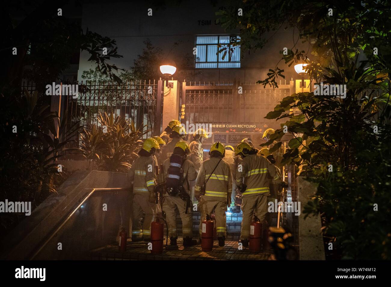 Fire men try to extinguish a fire at the door of Yau Tsim District Police  Headquarter during the protest.Pro-democracy protesters have continued weekly rallies on the streets of Hong Kong against a controversial extradition bill since June 9, as the city plunged into crisis after waves of demonstrations and several violent clashes. Hong Kong's Chief Executive Carrie Lam apologised for introducing the bill and declared it 'dead', however protesters have continued to draw large crowds with demands for Lam's resignation and completely withdraw the bill. Stock Photo