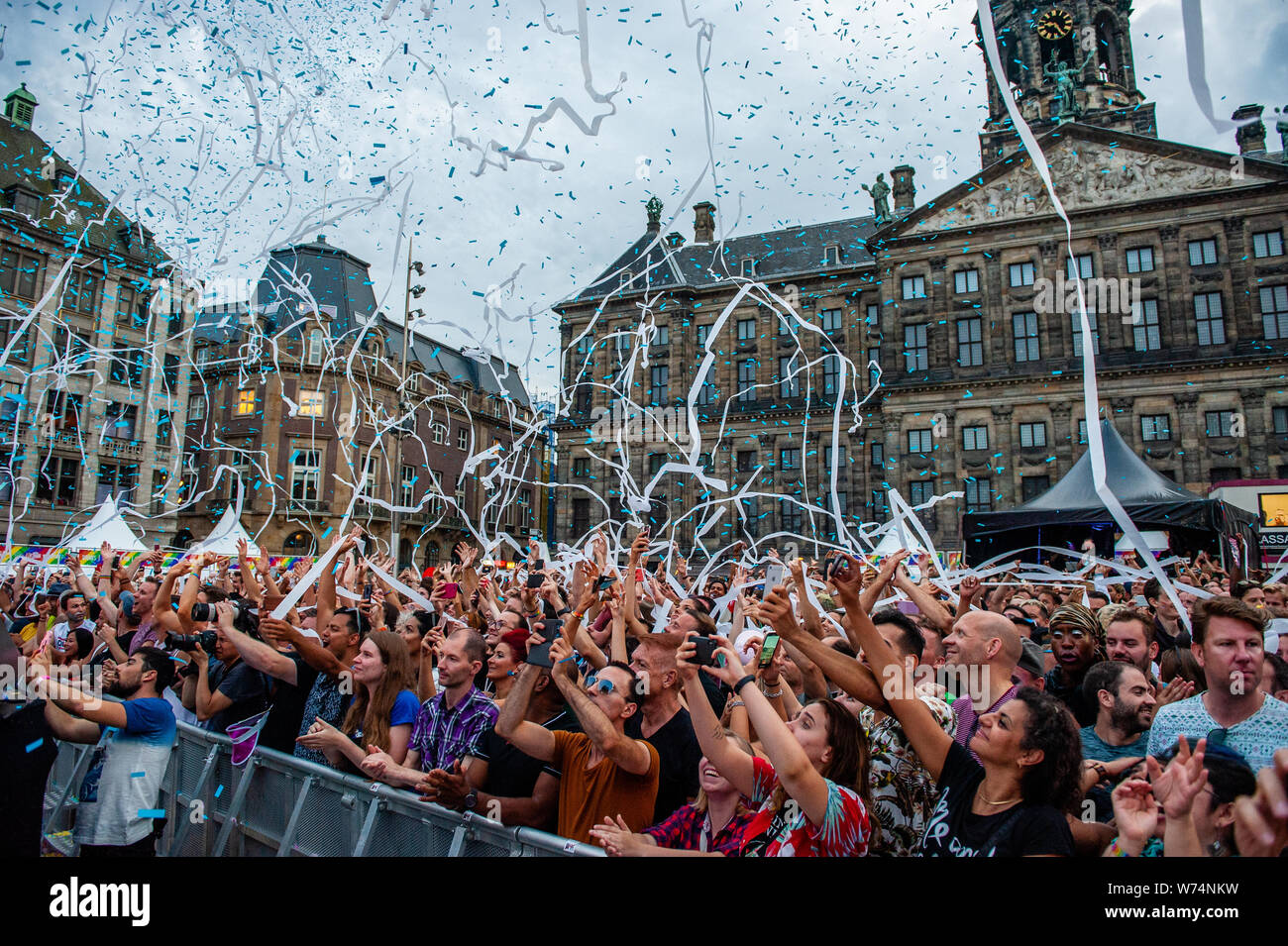 Amsterdam, Netherlands. 04th Aug, 2019. People are seen having fun while canons releases confetti during the performance of Netta. 2018 Eurovision Winner Representing Israel Netta, gave a performance during the final concert of the Pride Amsterdam at the Dam square, in the center of the city. On Sunday, the official end - party, where there is always a colourful collection of artists enters the stage. Credit: SOPA Images Limited/Alamy Live News Stock Photo