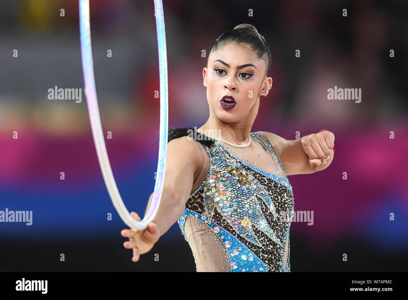 Lima, Peru. 4th Aug, 2019. BARBARA DOMINGOS from Brazil rolls the hoop down her arm during the competition held in the Polideportivo Villa El Salvador in Lima, Peru. Credit: Amy Sanderson/ZUMA Wire/Alamy Live News Stock Photo