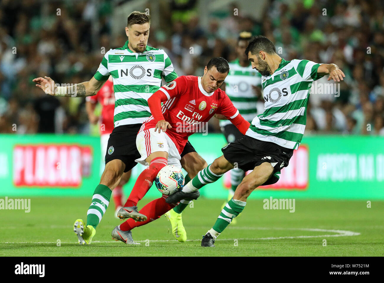 Lisbon, Portugal. 04th Aug, 2019. Raul de Tomás of SL Benfica (C) vies for the ball with Sebastián Coates of Sporting CP (L) and Luís Neto of Sporting CP (R) during the Final Cândido de Oliveira SuperCup 2019 football match between SL Benfica vs Sporting CP.(Final score: SL Benfica 5 - 0 Sporting CP) Credit: SOPA Images Limited/Alamy Live News Stock Photo